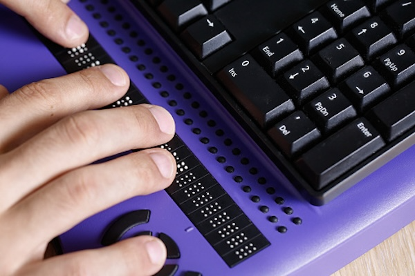 person using a braille keyboard